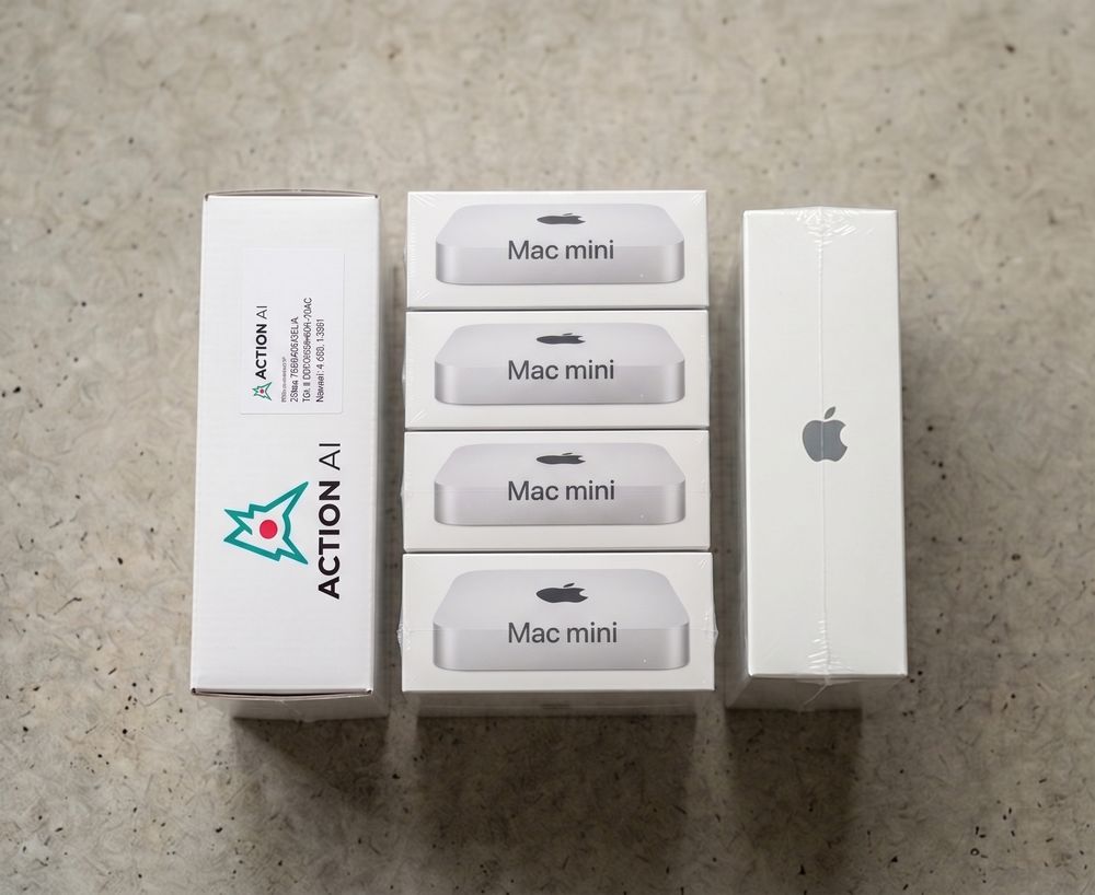 The Action Box bundle laid out — an Action AI shipping carton alongside the Mac mini Action Cell units it ships with.